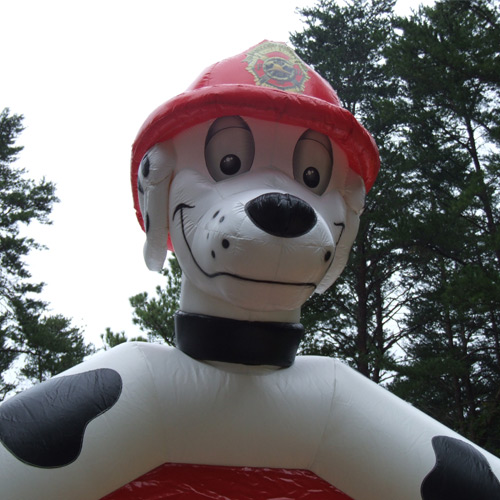 Marshall the Paw Patrol Bounce House character is watching to make sure your guests have a great time with a rental from Carolina Fun Factory